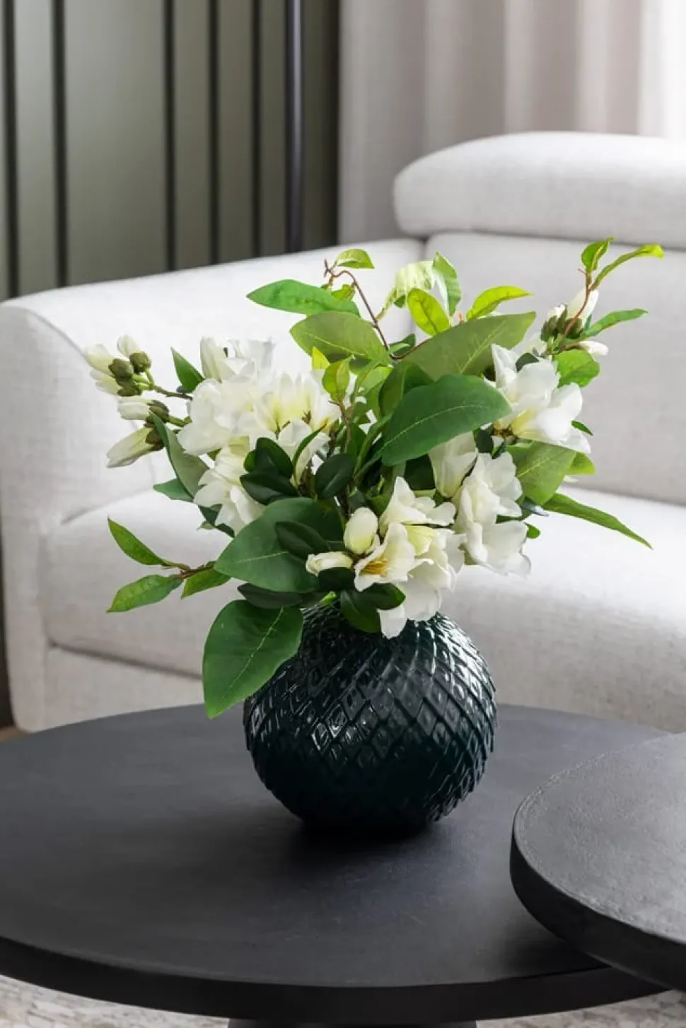 Artificial azalea flowers in a round vase