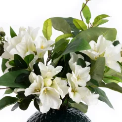Artificial azalea flowers in a round vase