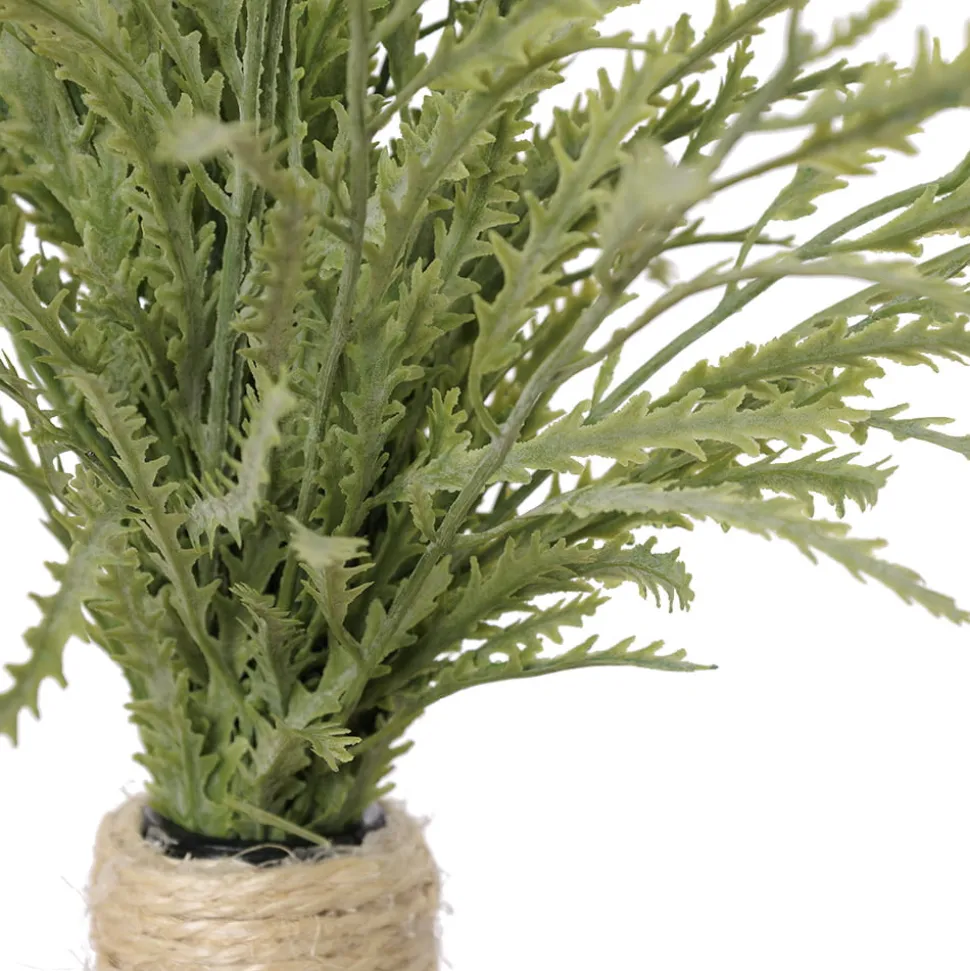 Artificial staghorn fern in a glass vase
