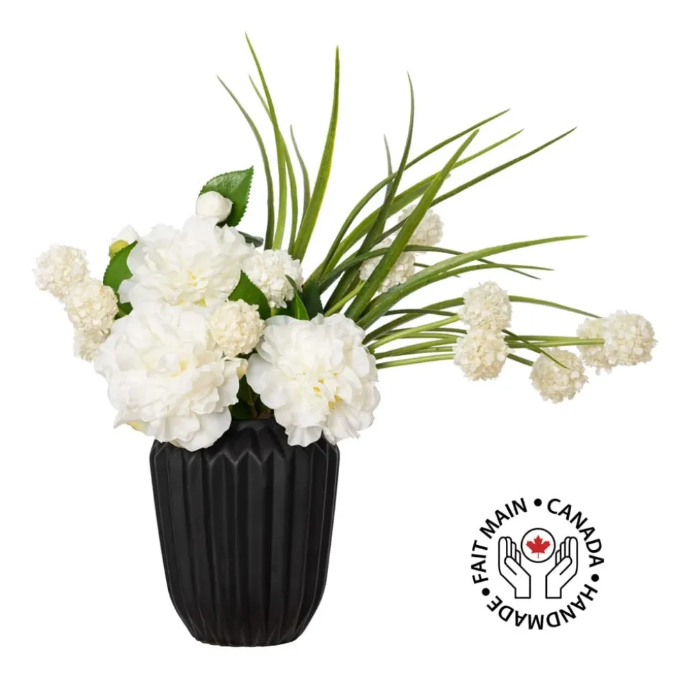 Small white flower bouquet in a black vase